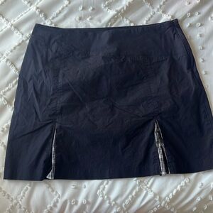 A mini skirt with plaid designs in the front.